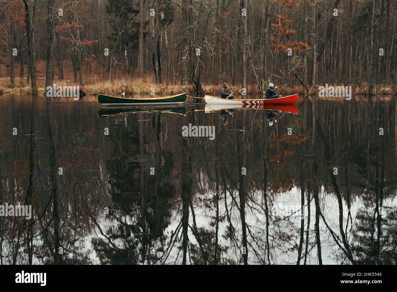 Canoe paddling lifestyle two persons in a boat towing an empty vessel