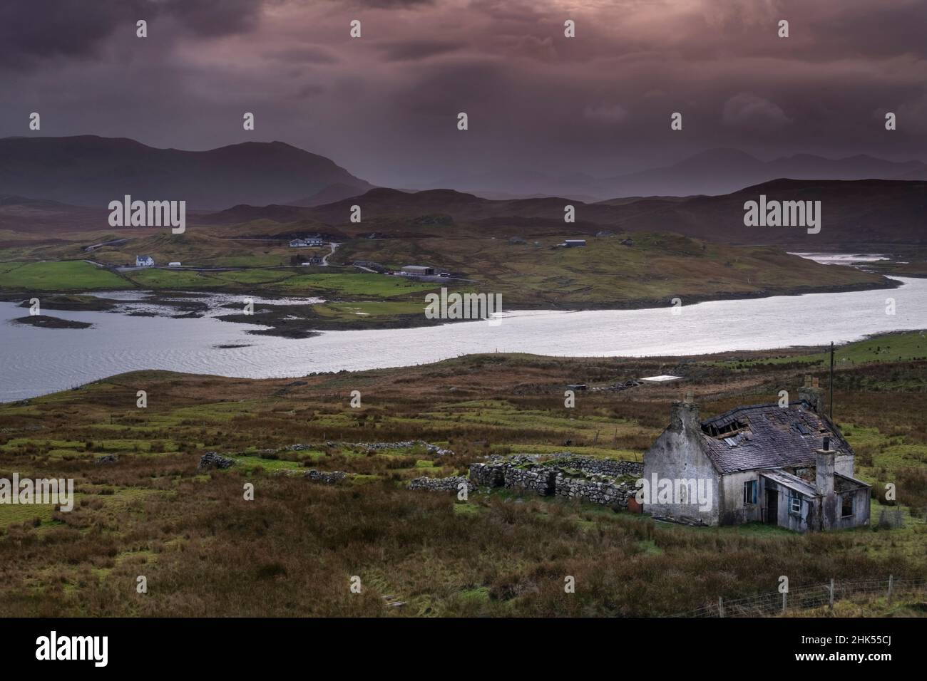 Abandoned Croft backed by Loch Eireasort and the Harris Hills, near Baile Ailein, Isle of Lewis, Outer Hebrides, Scotland, United Kingdom, Europe Stock Photo
