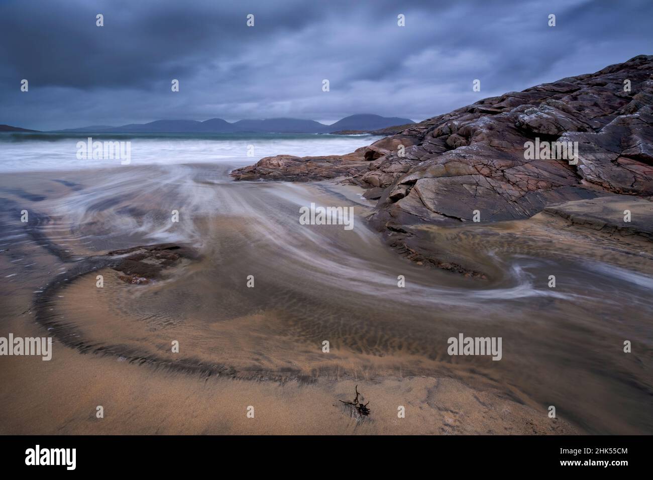 Swirling Wave Patterns at Luskentyre Beach backed by the Harris Hills, Isle of Harris, Outer Hebrides, Scotland, United Kingdom, Europe Stock Photo