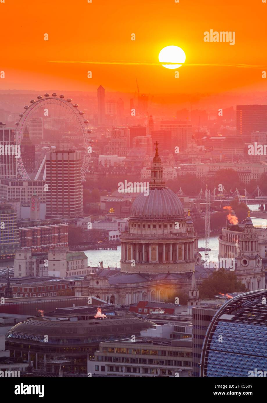 View of sun setting over London Eye and St. Paul's Cathedral from the Principal Tower, London, England, United Kingdom, Europe Stock Photo