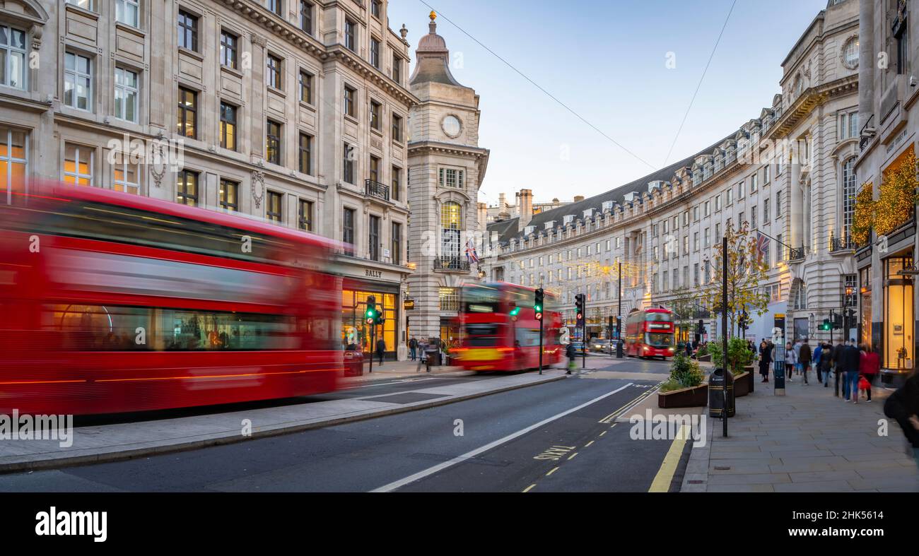 View of red buses and shops on Regent Street at Christmas, London, England, United Kingdom, Europe Stock Photo