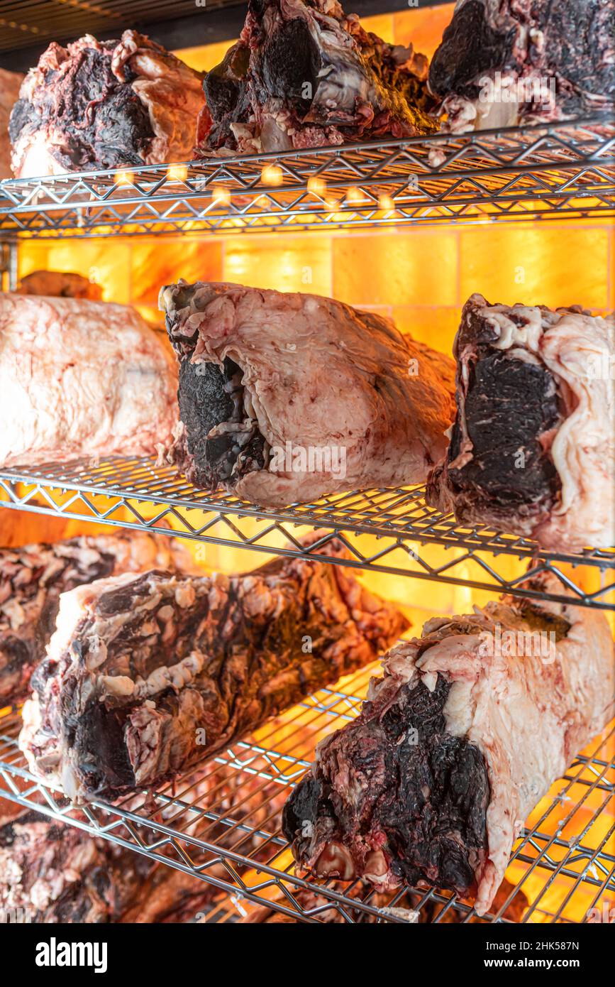 Beef hung and lined up in a dry aged beef cabinet Stock Photo