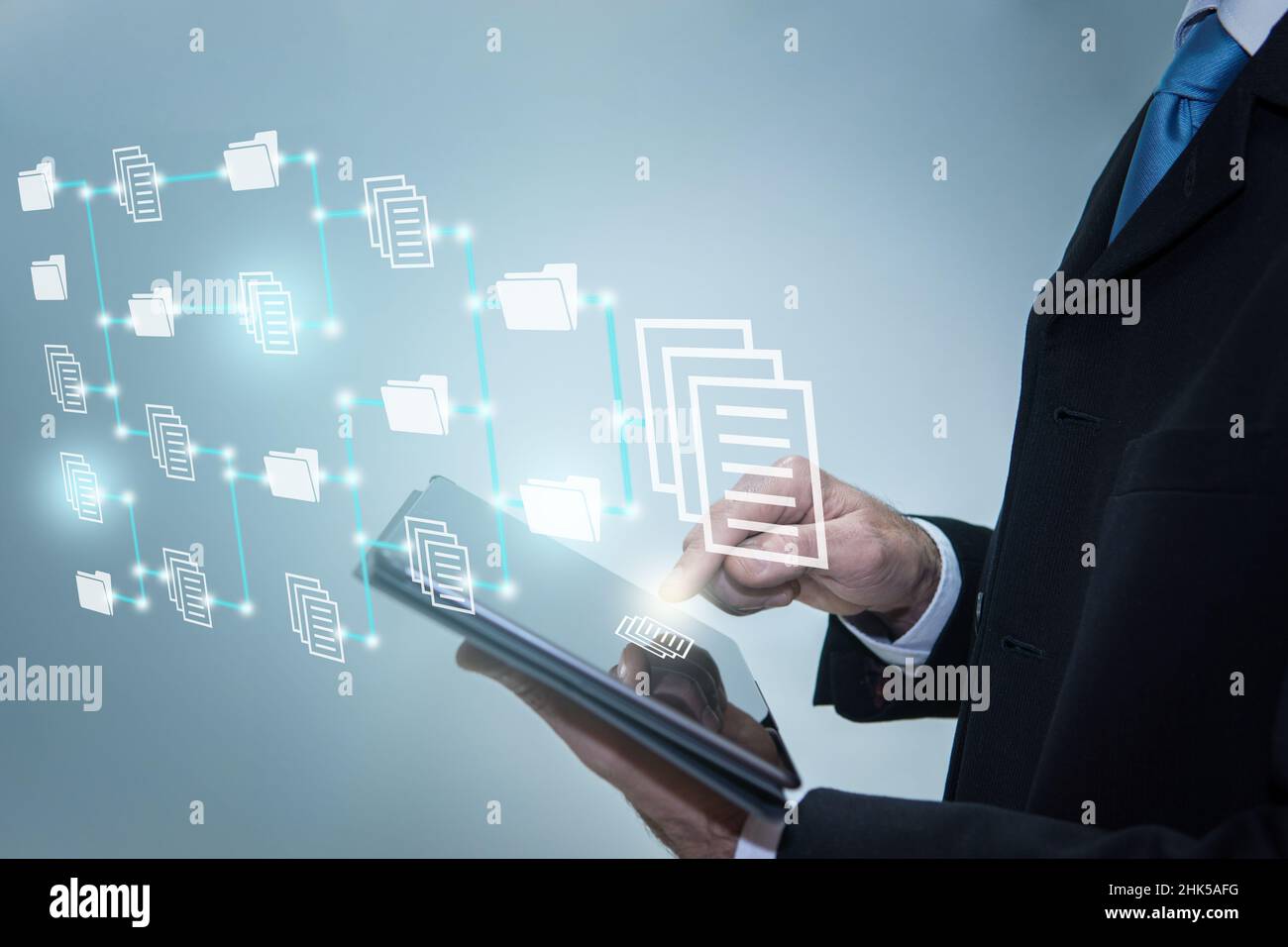Businessman touching icons on digital tablet. Document Management System, online documentation datab Stock Photo