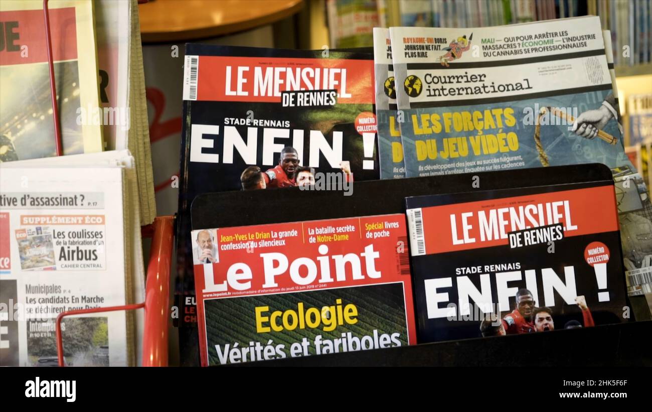 Paris, France - June, 2019: Magazine covers and newspapers on stall. Action. Close-up of bright magazine headlines with popular topics at moment. Maga Stock Photo