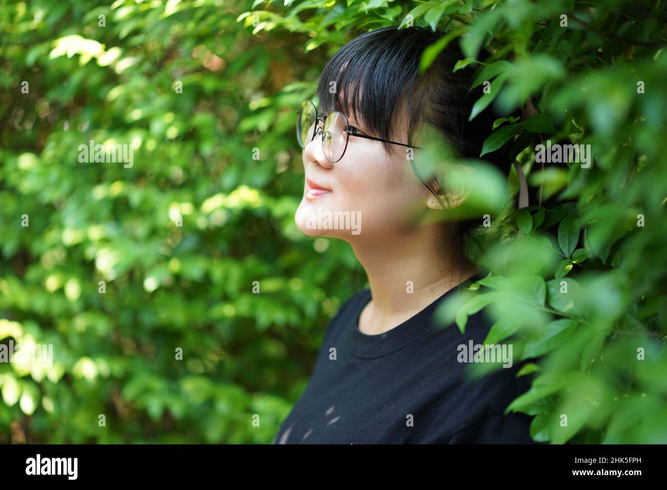 Portrait of the Asian glassese Thai woman is standing in the garden in the  morning Stock Photo - Alamy