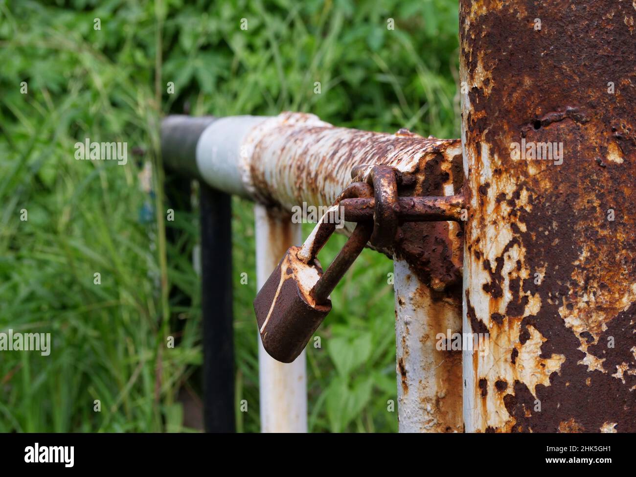 Rusty padlock hanging in the street alley Stock Photo