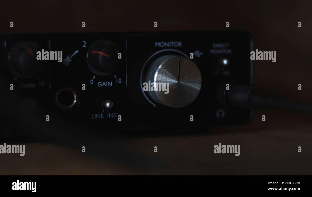 Audio interface with plugged in headphone jack. Close up of a hand