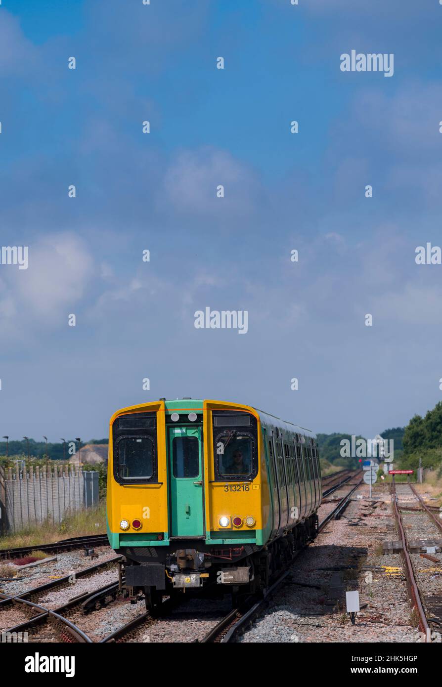 Southern Railway class 313 passenger train travelling along track in the UK. , Stock Photo