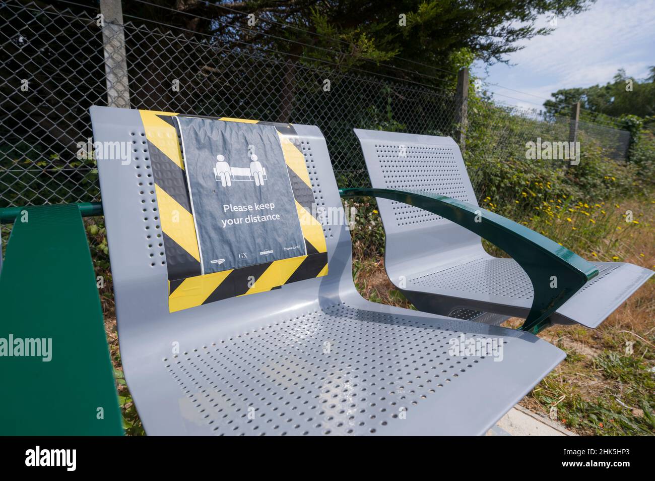 Social distancing sign on seating on a railway platform, during the coronavirus pandemic in June 2020, England, UK. Stock Photo
