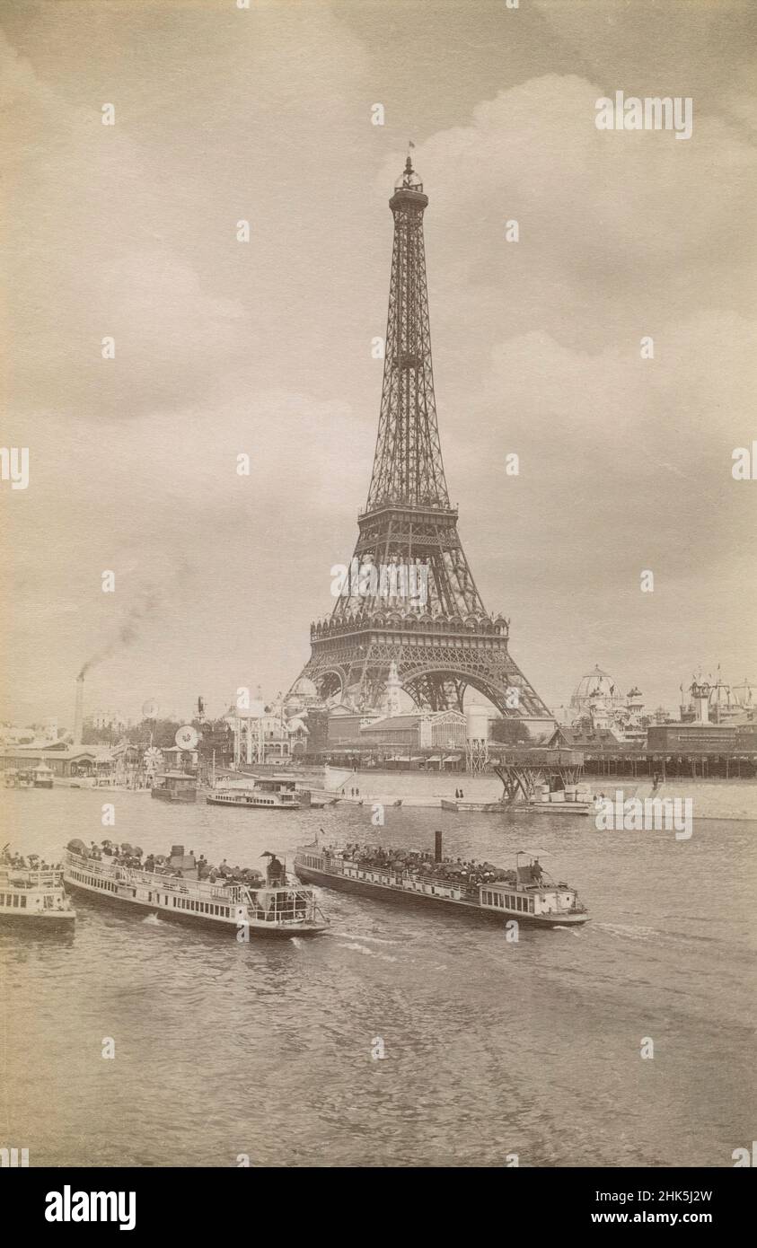 Antique circa 1889 photograph of the Eiffel Tower during the 1889 World's Fair in Paris, France. Ferry boats carry tourists crossing the river Seine. SOURCE: ORIGINAL ALBUMEN PHOTOGRAPH Stock Photo