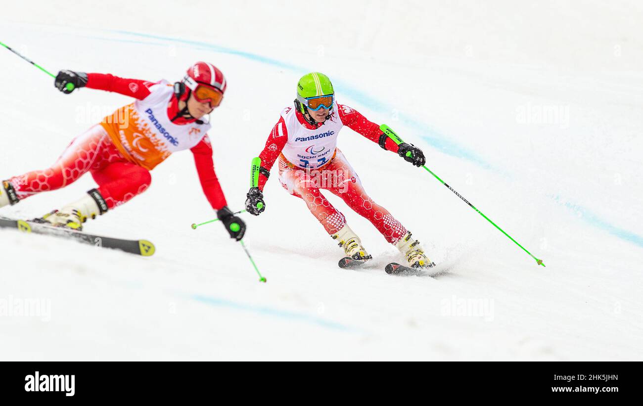 Maciej KREZEL of Poland follows the shouts of his guide in the Mens Alpine Skiing Giant Slalom during the 2014 Winter Paralympic Games at the Rosa Khu Stock Photo