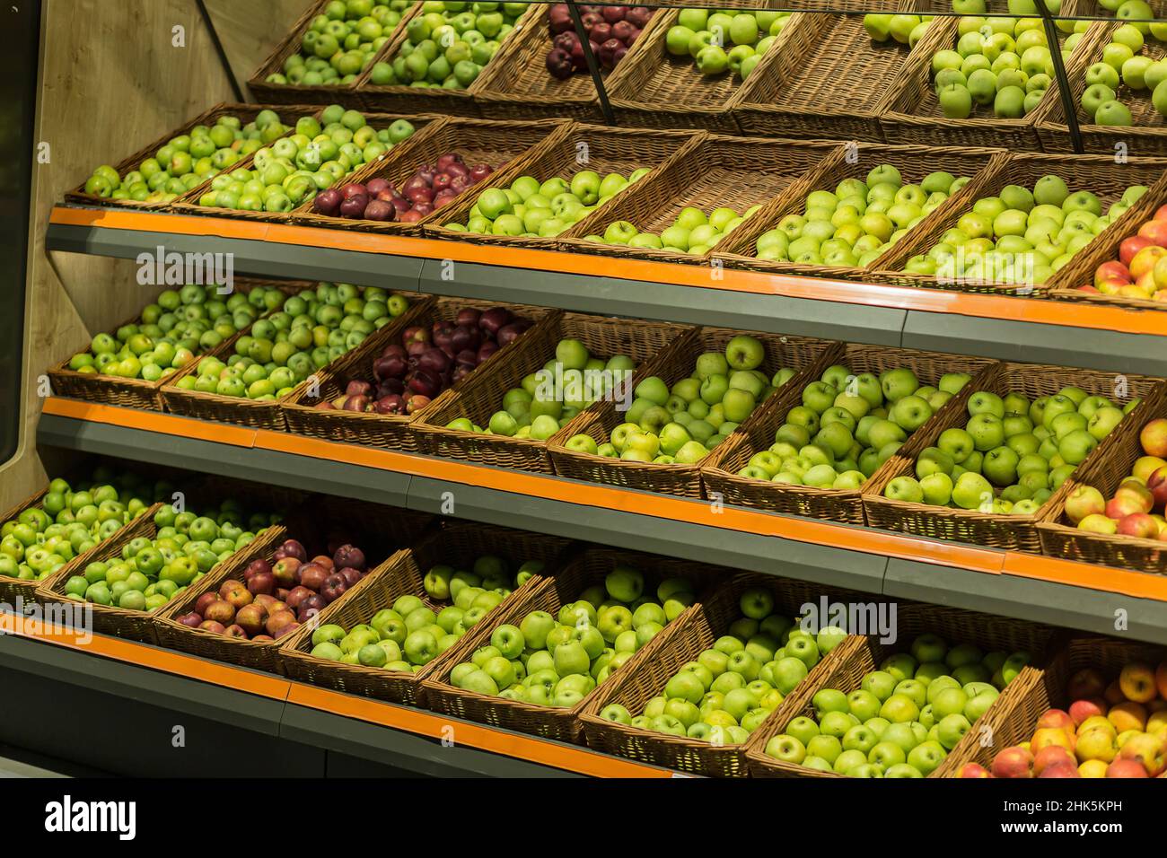 Shelves boxes with fruit colorful apples in the supermarket store on