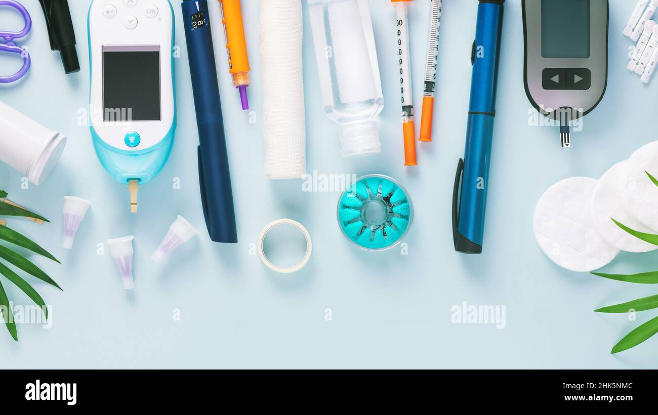 Diabetic disease banner with glucose meter, test strips for determining blood sugar levels, syringes for insulin injections, needles, sanitizing on a Stock Photo