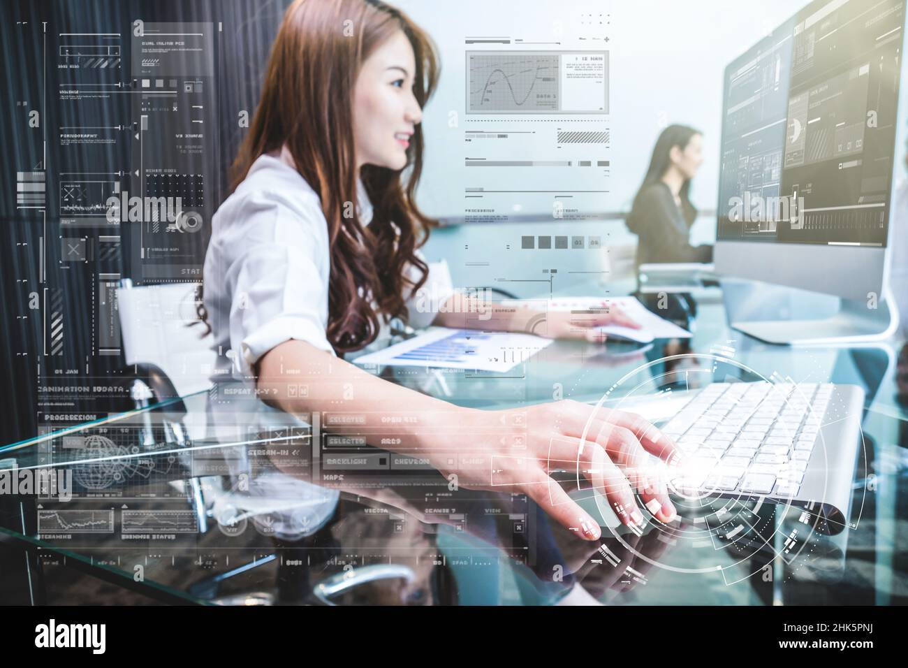 Closeup hand young asian business woman pressing the keyboard of computer with technology digital virtual screen for working in the modern Office over Stock Photo