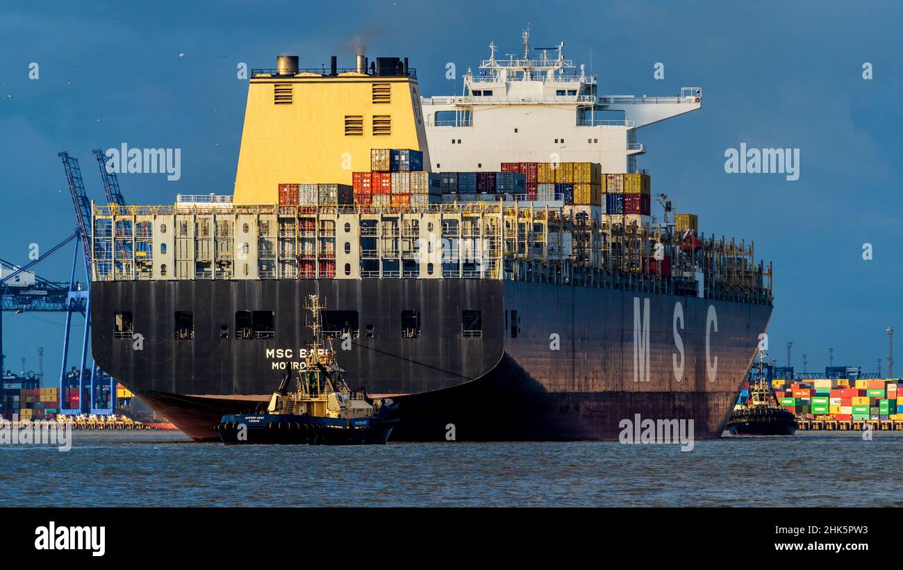 Global Trade Shipping - Container Ship MSC Bari being manoeuvred into port at Felixstowe UK. Stock Photo