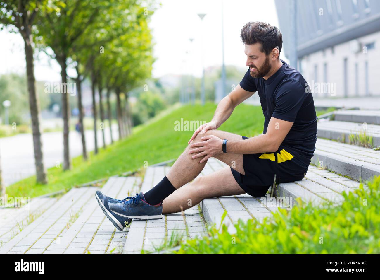 Athlete male injured during training, has severe leg pain, muscle aches