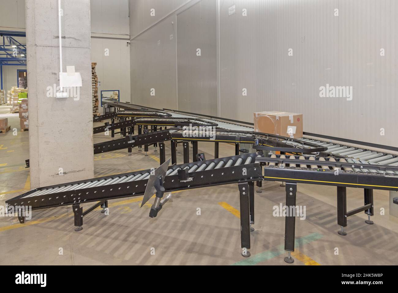 Long Conveyor Sorting Rollers in Distribution Warehouse Stock Photo