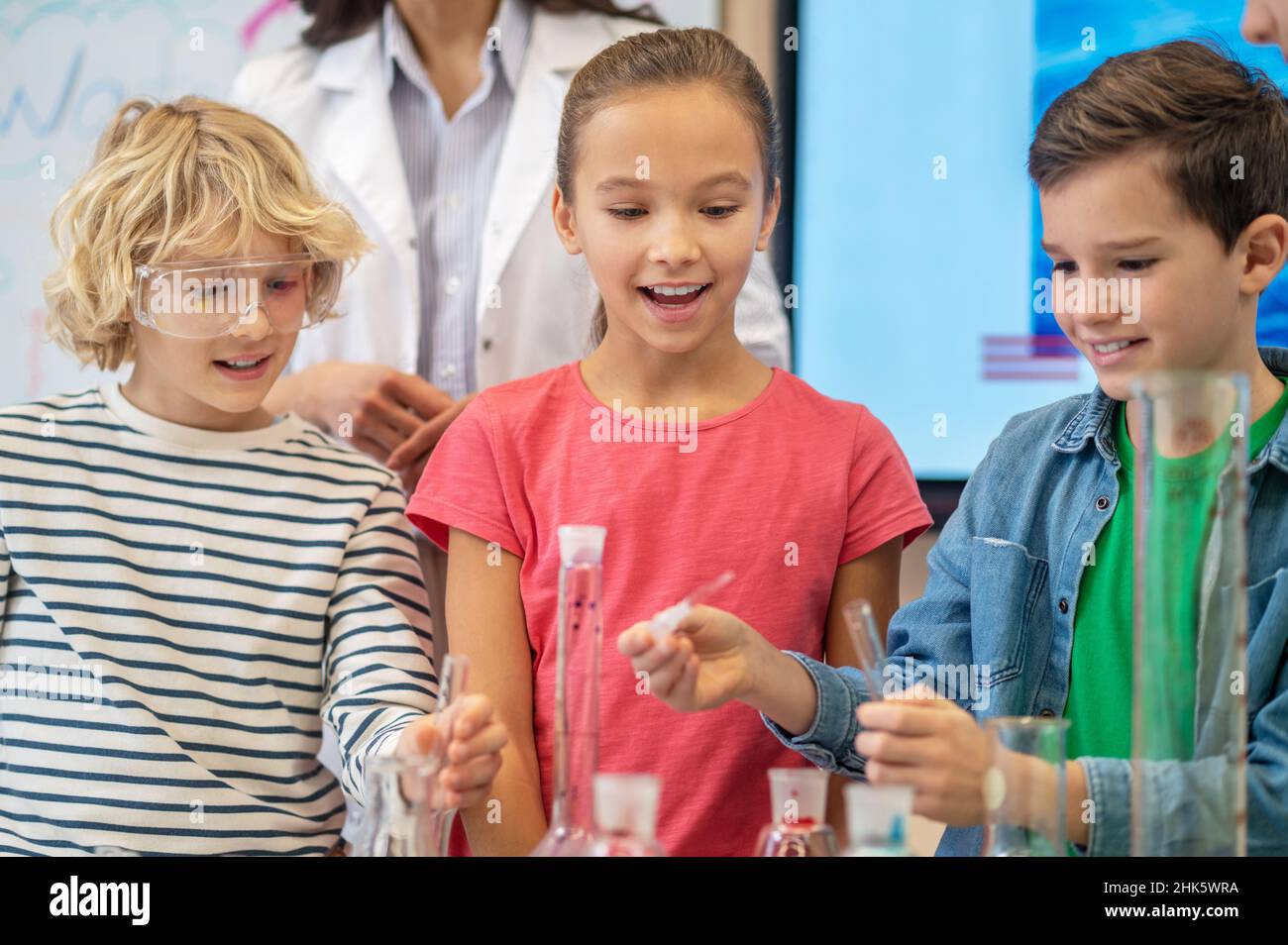 Children doing liquid experiment in chemistry class Stock Photo