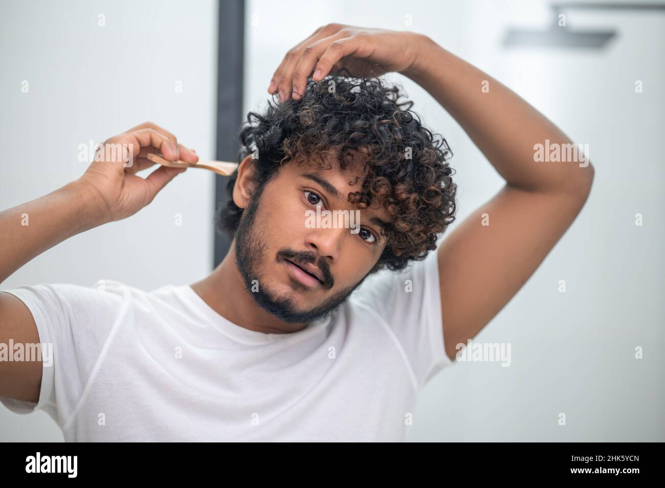 Portrait man combing hair hi-res stock photography and images - Alamy