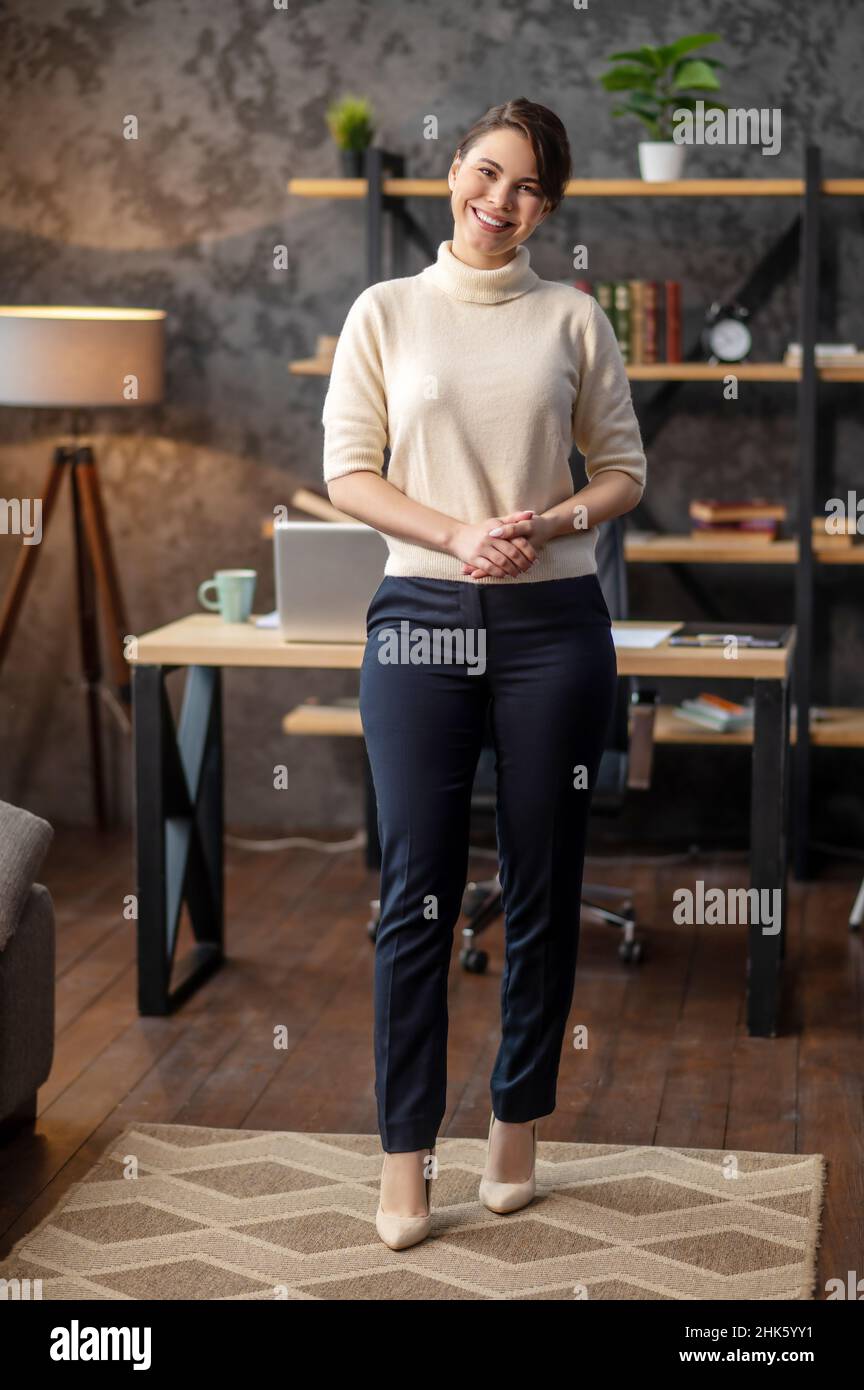 Cheerful lady posing for the camera in a living room Stock Photo - Alamy