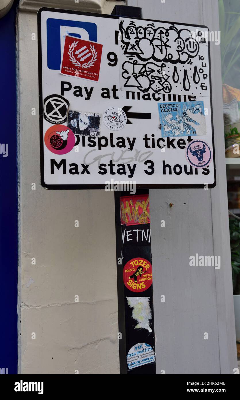 Vandalism of parking Pay at machine road sign with graffiti, UK Stock Photo