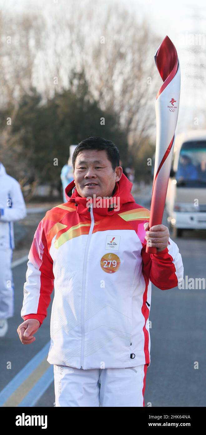 Beijing, China. 2nd Feb, 2022. Torch bearer Hu Guoqing runs with the ...