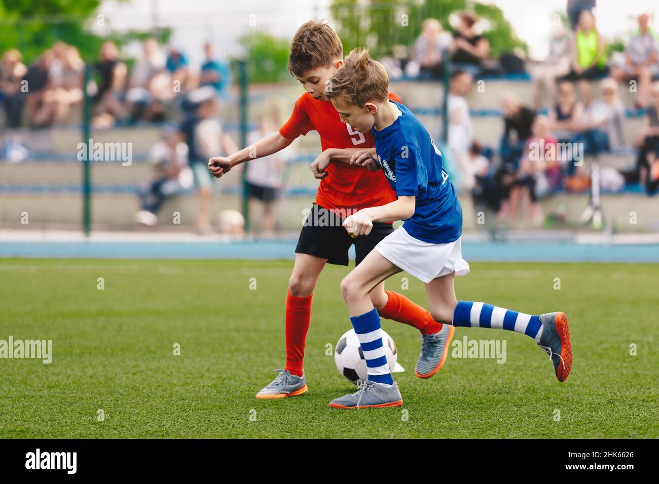 Two Kids Playing Football Ball on Grass Field. Happy School Boys ...