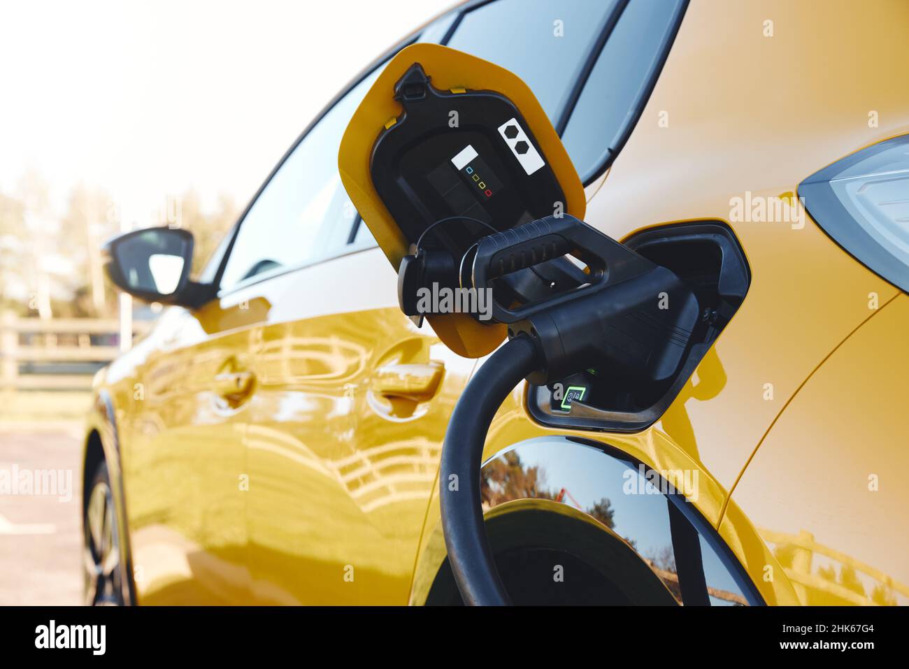 Close up of power supply plugged into an electric car being charged using a rapid charger cable Stock Photo