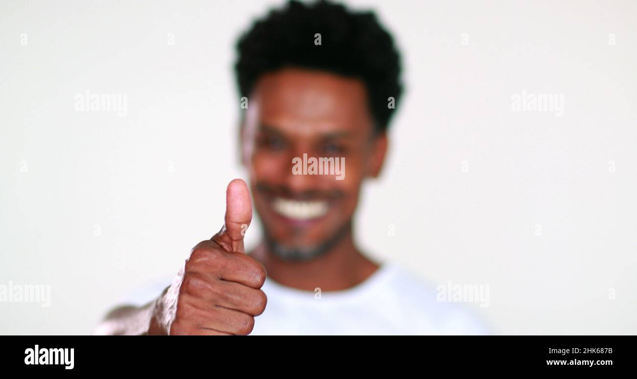Black guy giving thumb to camera, feeling positive and optimistic Stock Photo