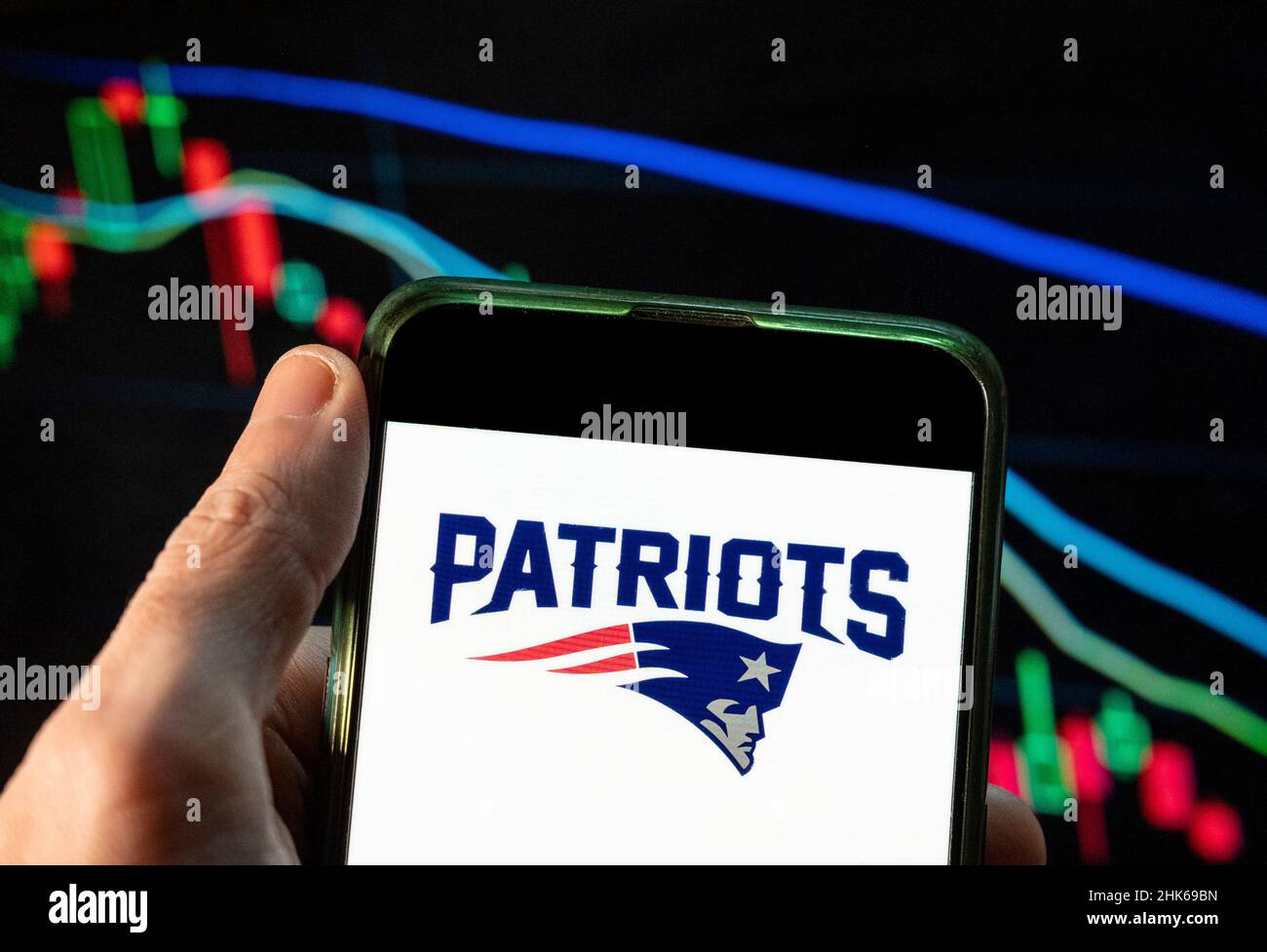 China. 4th Dec, 2021. In this photo illustration the American professional National Football League team (NFL), New England Patriots, logo seen displayed on a smartphone with an economic stock exchange index graph in the background. (Credit Image: © Budrul Chukrut/SOPA Images via ZUMA Press Wire) Stock Photo