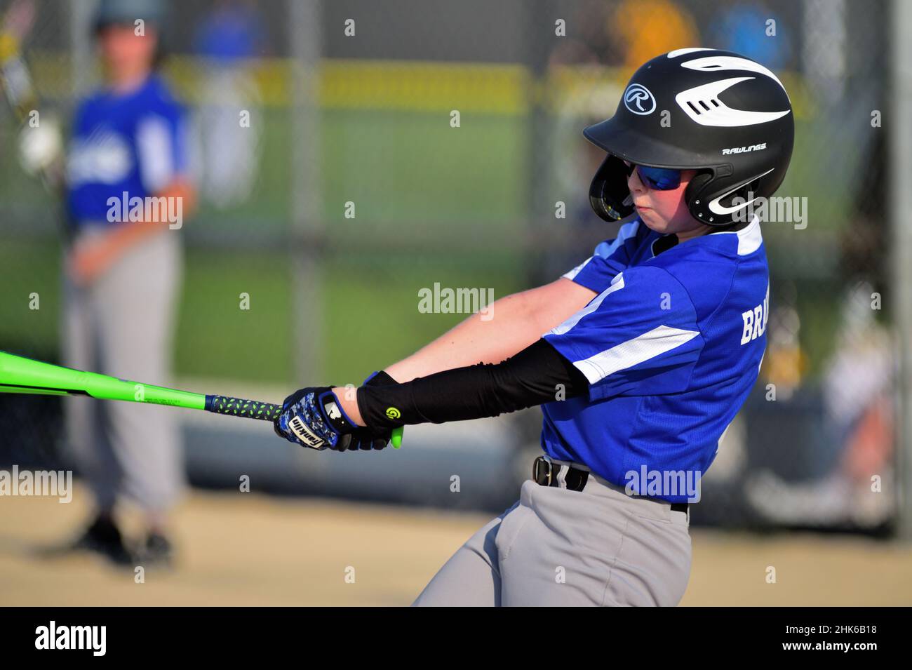 Sycamore, Illinois, USA. A young teen swinging at a pitch during a youth league baseball game. Stock Photo