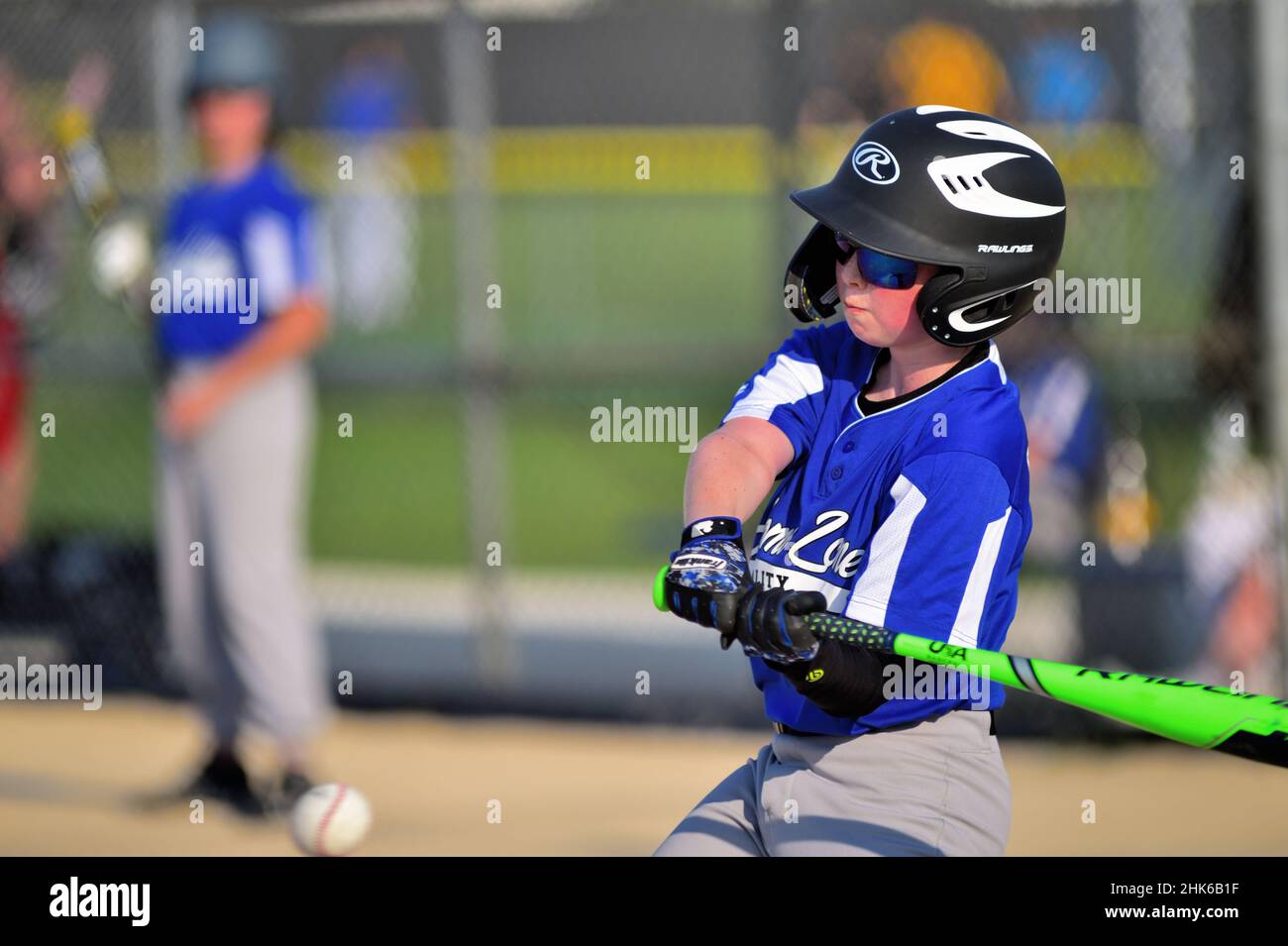 Sycamore, Illinois, USA. A young teen swinging at a pitch during a youth league baseball game. Stock Photo