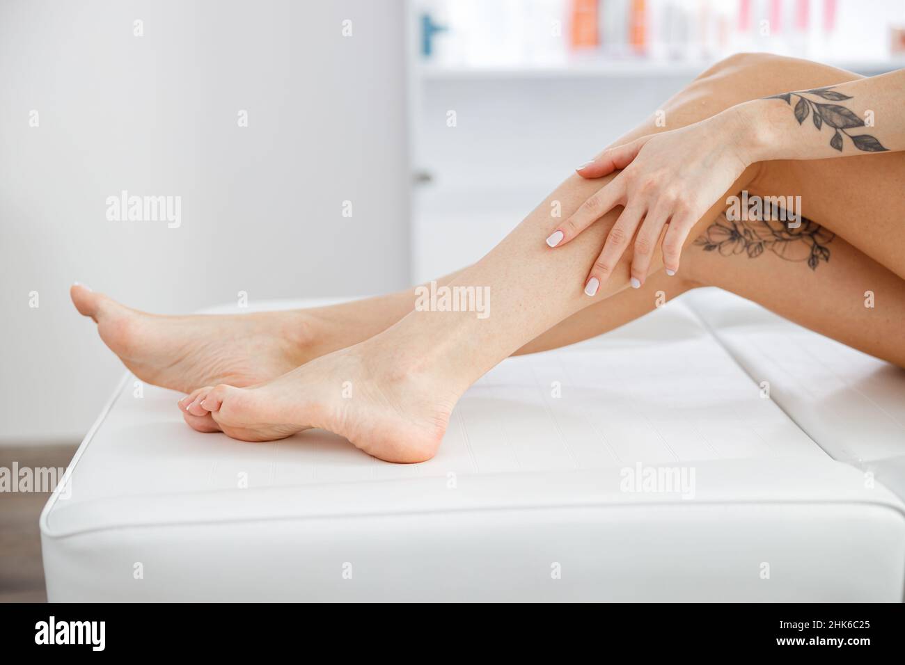 Female legs after epilation procedure in beauty salon Stock Photo