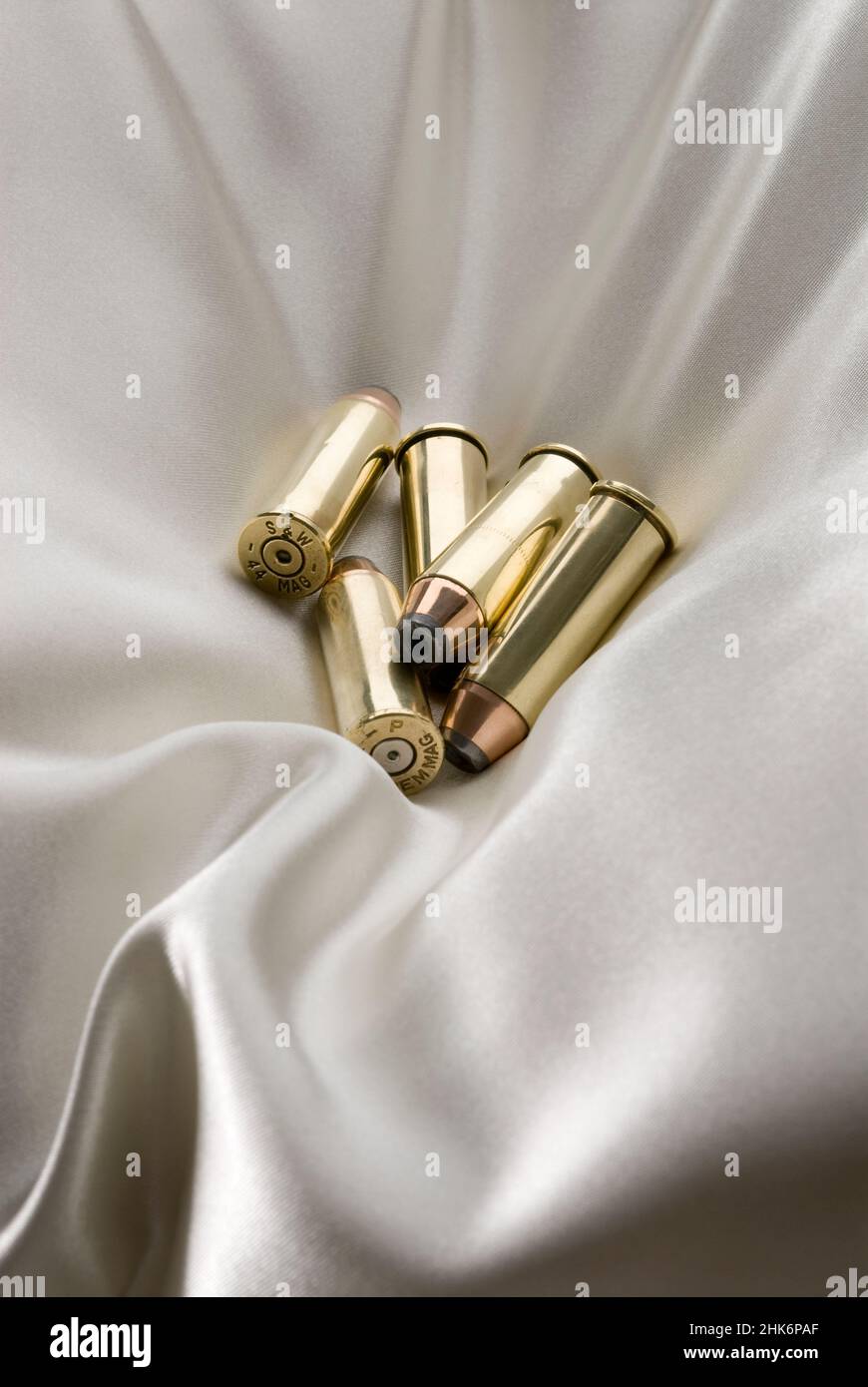 Group of bullets laying on satin pillow Stock Photo Alamy