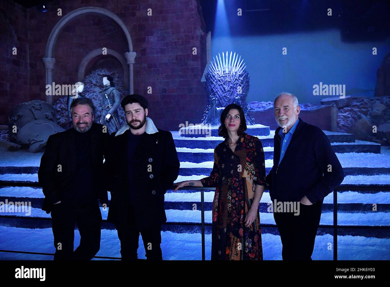 Actors from the TV show Game of Thrones: Ian Beattie who plays Meryn Trant, Daniel Portman who plays Podrick Payne, Natalia Tena who plays Osha and Ian McElhinney who plays Barristan Selmy, pose for a photograph in front of the throne in the 'The Destroyed Throne Room' set during the media preview day for the opening of the new Game of Thrones studio tour at Linen Mill Studios in Banbridge, Northern Ireland, February 2, 2022. REUTERS/Clodagh Kilcoyne Stock Photo