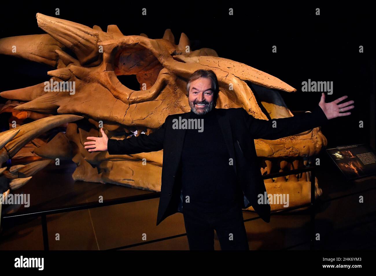 Actor Ian Beattie, who plays Meryn Trant in the TV show Game of Thrones, poses for a photograph in front of the skull of Drogon, one of the dragons from Westeros, during the media preview day for the opening of the new Game of Thrones studio tour at Linen Mill Studios in Banbridge, Northern Ireland, February 2, 2022. REUTERS/Clodagh Kilcoyne Stock Photo