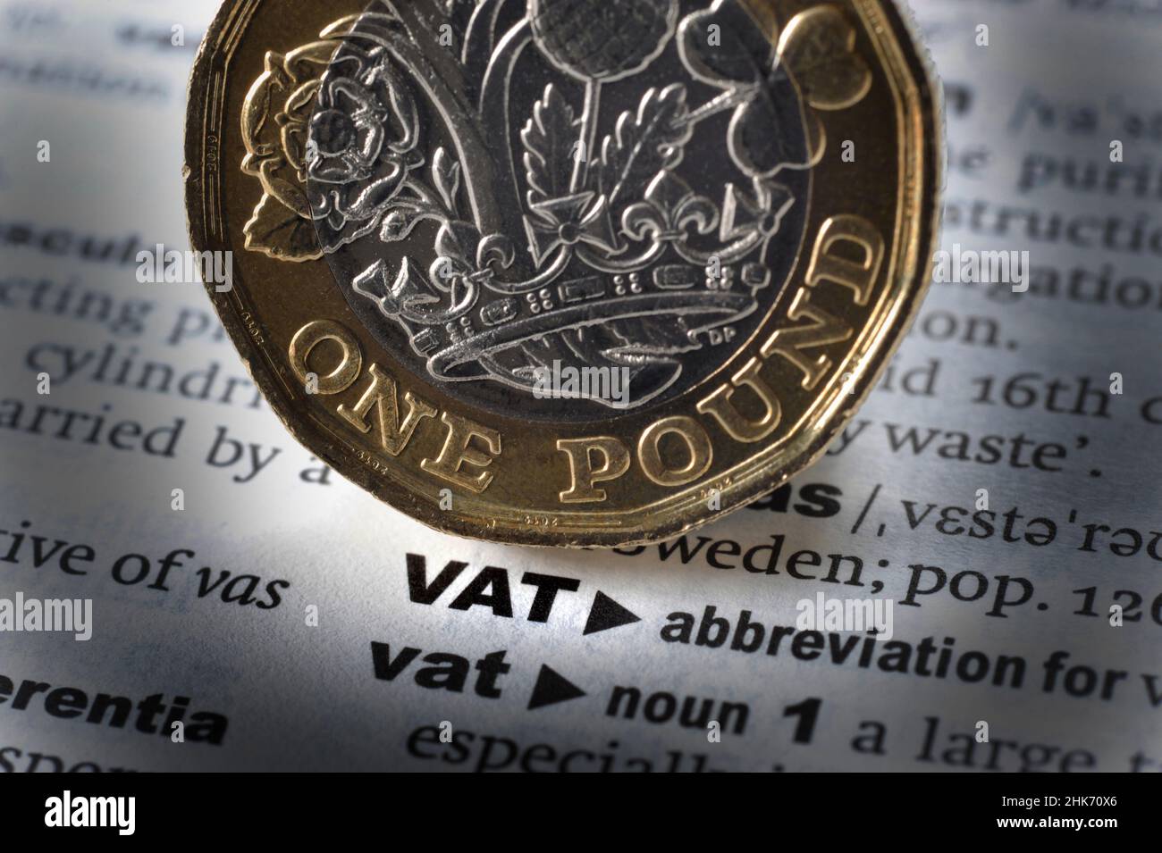 DICTIONARY DEFINITION OF WORD VAT WITH ONE POUND COIN RE VALUE ADDED TAX INFLATION COST OF LIVING ETC UK Stock Photo