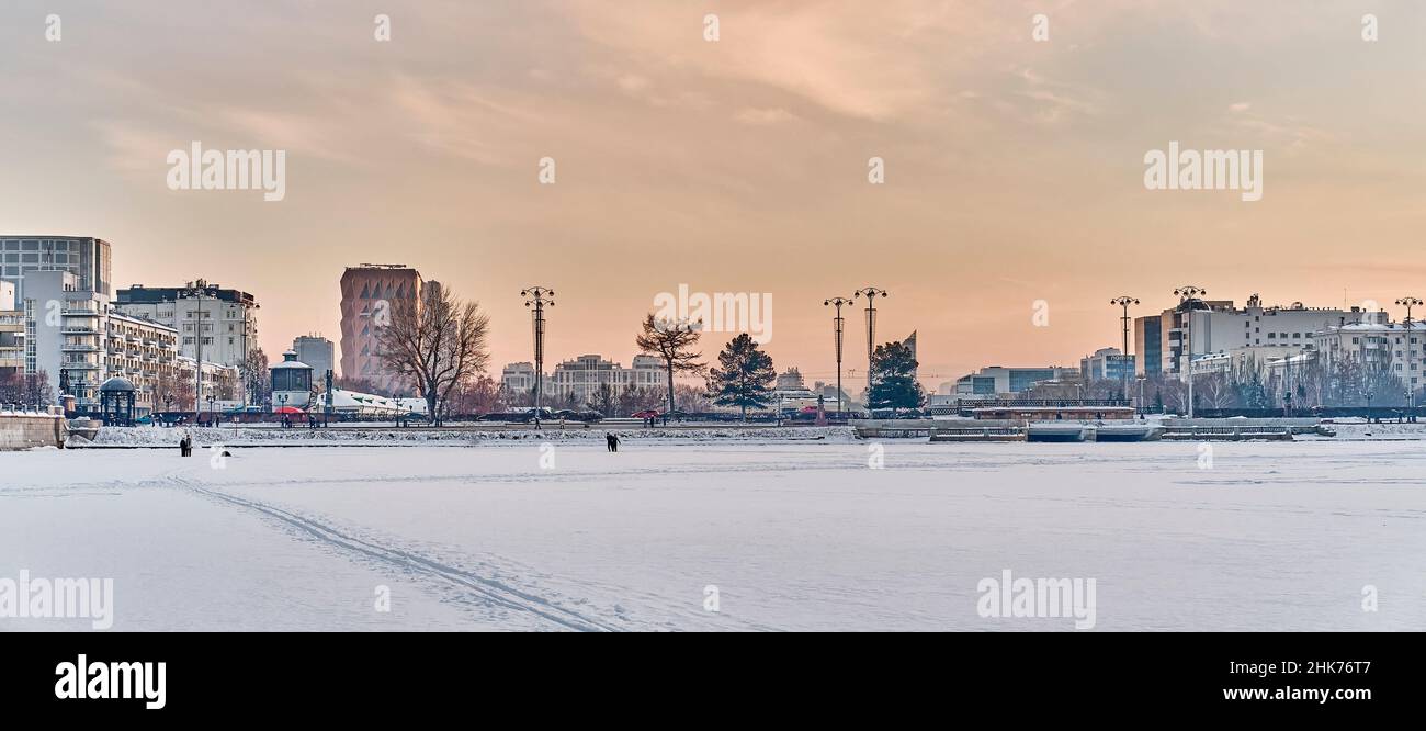 View of sights of downtown of Yekaterinburg, Russia, from ice of city pond, covered with snow. Stock Photo