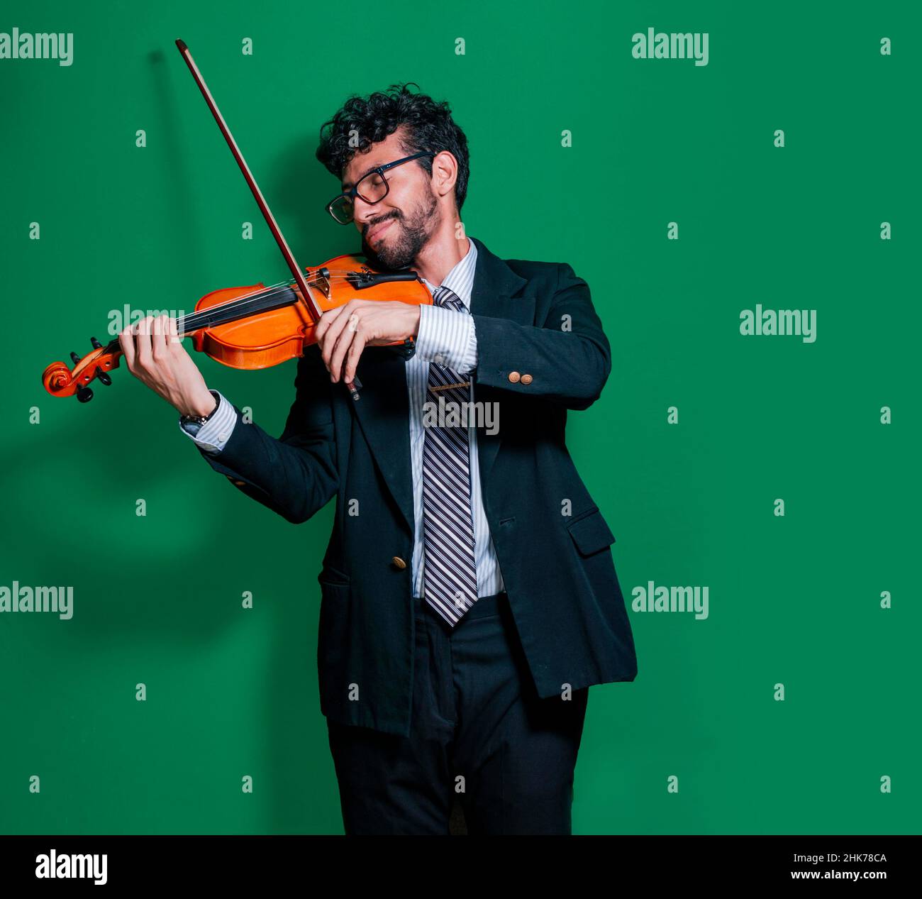 Attractive young man playing violin, guy playing violin isolated, master violinist isolated Stock Photo