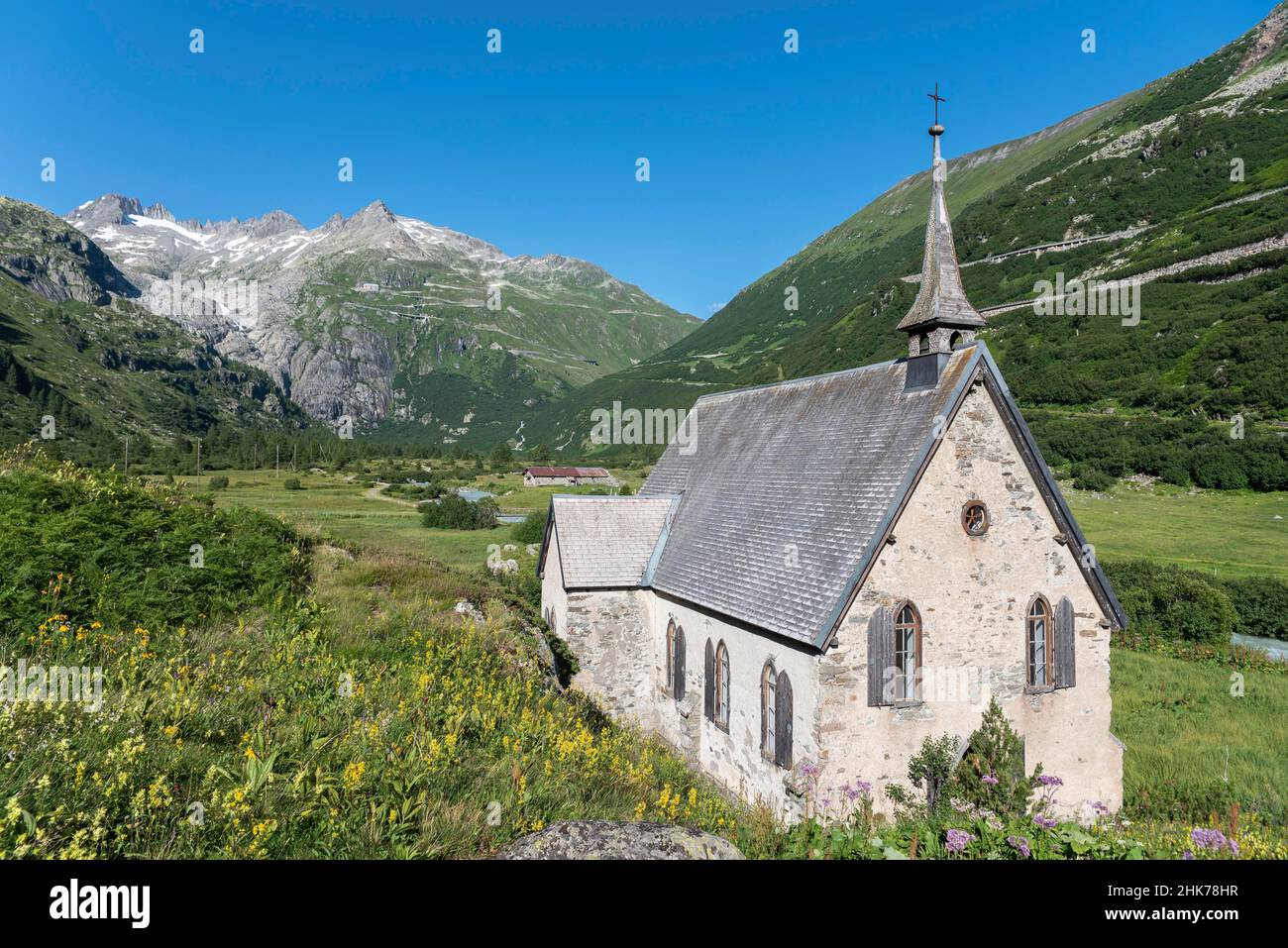 Landscape of the Rhone Valley in front of the Rhone Glacier and the Anglican Chapel in the hamlet of Gletsch, Oberwald, Valais, Switzerland Stock Photo