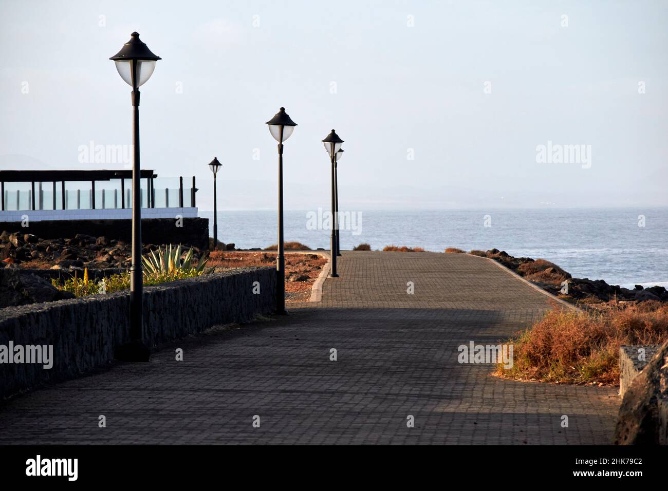 paseo maritimo or coastal walkway promenade in early morning at punta pechiguera playa blanca Lanzarote Canary Islands Spain Stock Photo