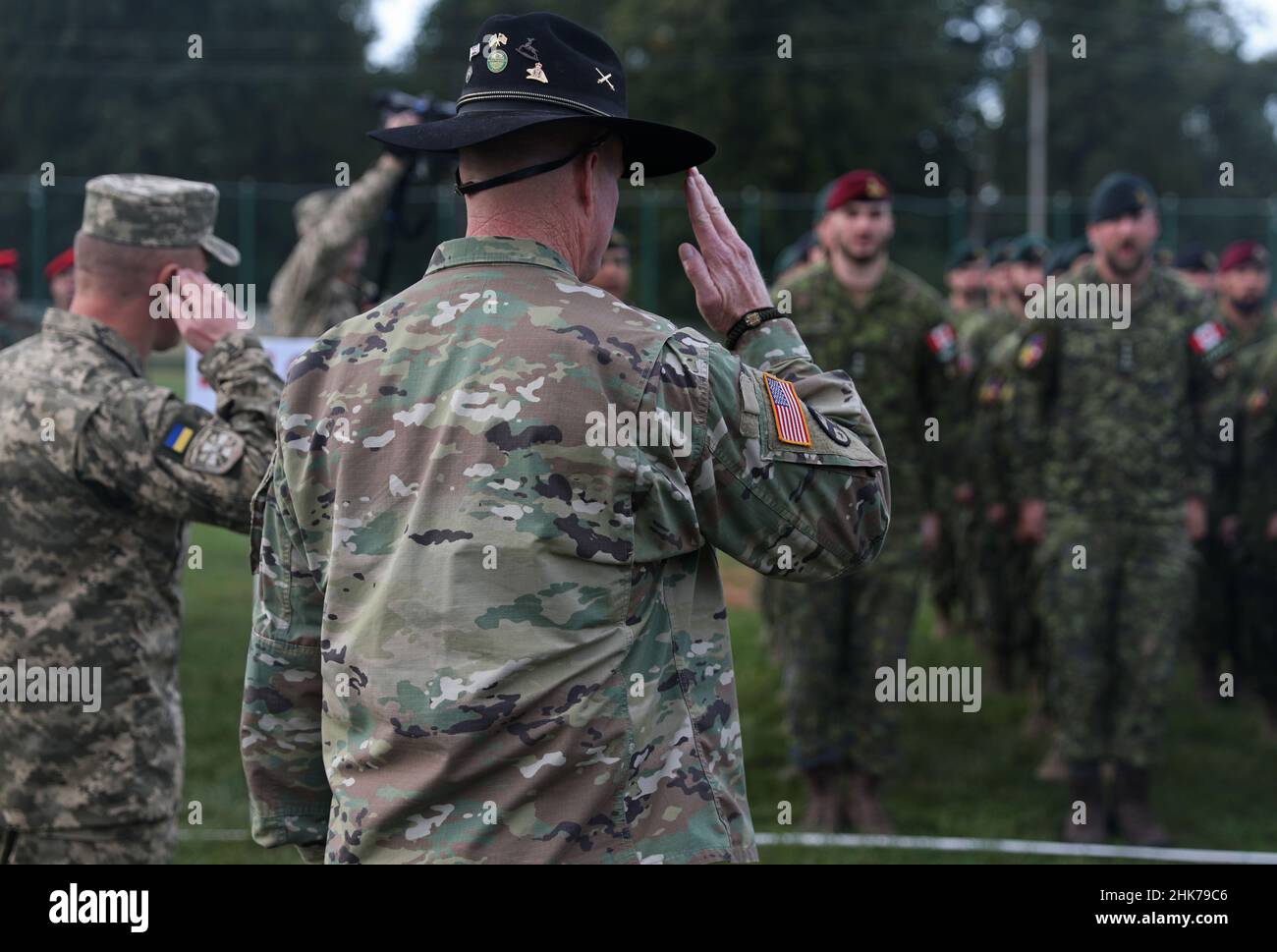 Yavoriv, Ukraine. 2nd Feb, 2022. U.S. Army Col. TIM CLEVELAND, one of the co-directors for Rapid Trident 2019 (RT19) and Joint Multinational Training Group-Ukraine Advisor, and Ukraine army Col. OLKSANDR ZHAKUN, the other co-director for RT19 and deputy commander of the operational command West, salute soldiers from participating countries during the RT19 opening ceremony, Sept. 13-28, 2019, at the Interna Stock Photo