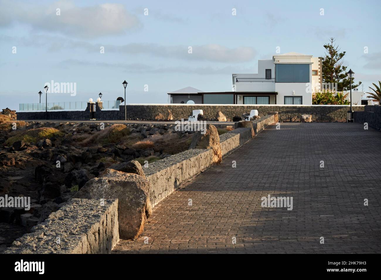 large villa paseo maritimo or coastal walkway promenade in early morning at punta pechiguera playa blanca Lanzarote Canary Islands Spain Stock Photo