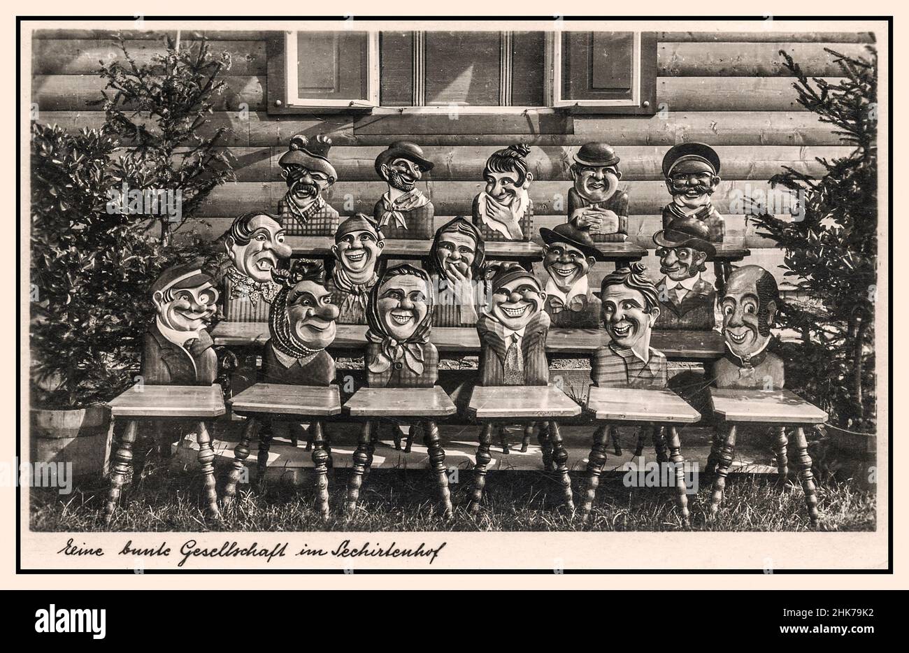 1930s Nazi Germany racist undertones stereotype Jewish features German humour propaganda with wooden carvings of a community of inhabitants some with anti semitic stereotype anti Jewish caricatures carvings on back of a group of wooden chairs in Schirlenhof France Alsace Germany  “A COLOURFUL GROUP OF INHABITANTS IN SCHIRLENHOF’ Postcard Stock Photo