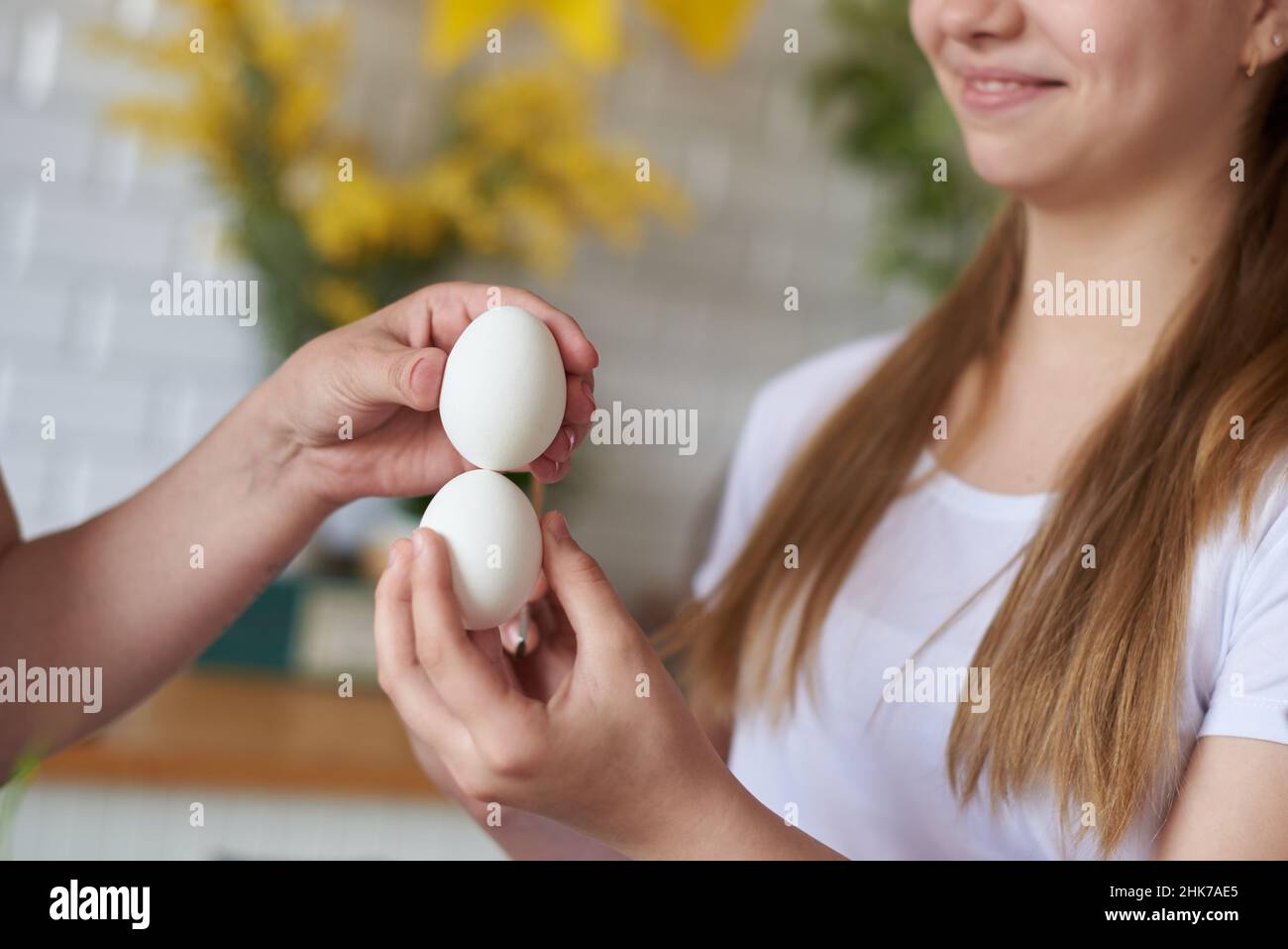 Two hands knock with eggs on the holiday of easter. Stock Photo