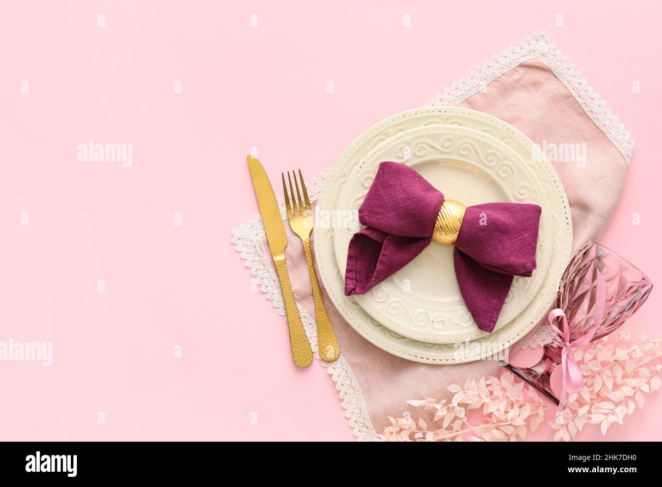 Stylish table setting with flowers on pink background Stock Photo