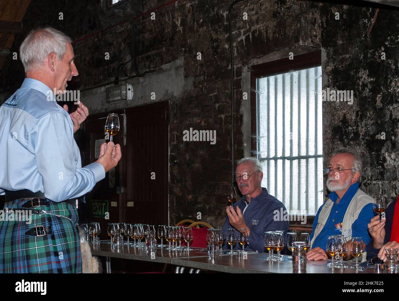 Sommelier gives a scotch whisky tasting at the famous single malt Talisker Distillery on the Isle of Skye, Inner Hebrides, Scotland, UK Stock Photo