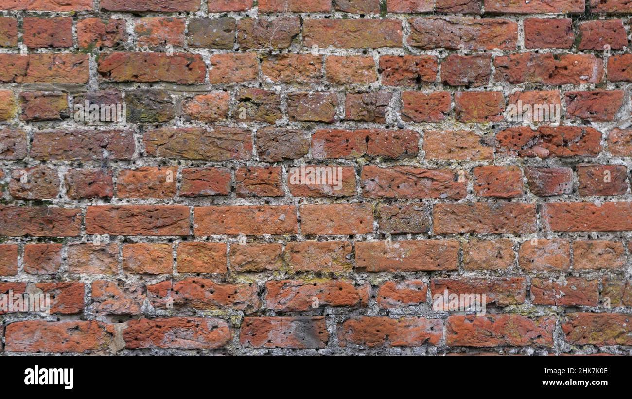 Full frame dark coarse brick wall background with copy space Stock Photo