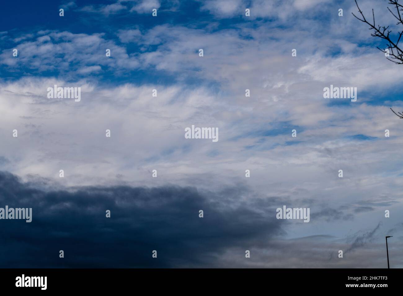 Blue sky shrouded in gray dark clouds Stock Photo