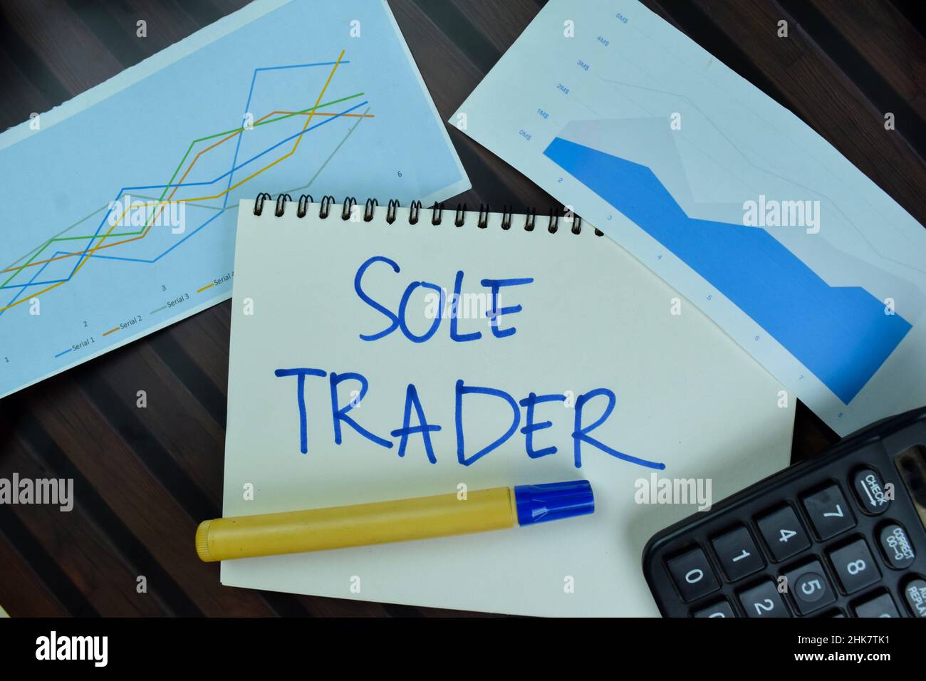 Sole Trader write on a book isolated on Wooden Table. Stock Photo